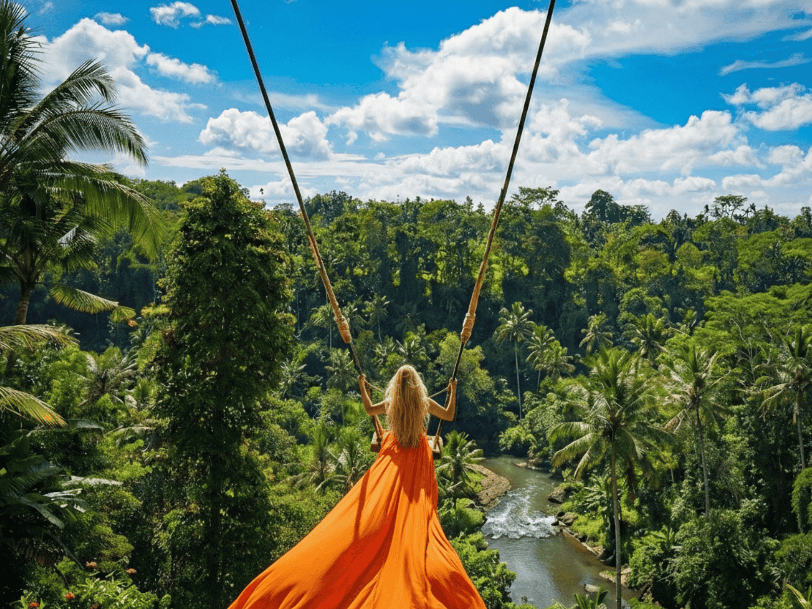 Traveler enjoying the Bali swing above a jungle in Ubud, Bali